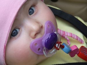 What should I know about giving my breastfed baby a pacifier? 